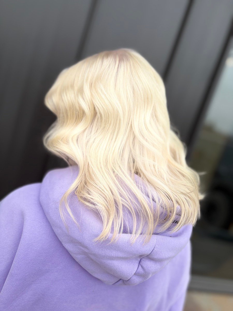 Bright blonde hair with soft waves from the back