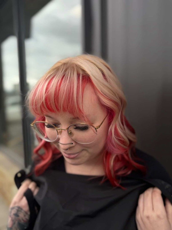 Blonde hair with red money piece and bangs