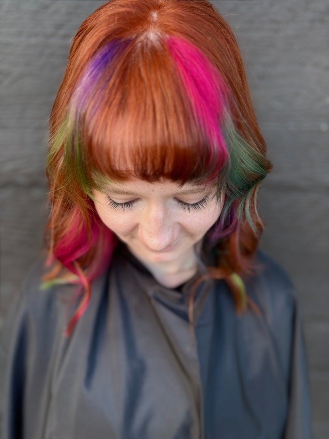 Copper hair with pink and violet panels and bangs
