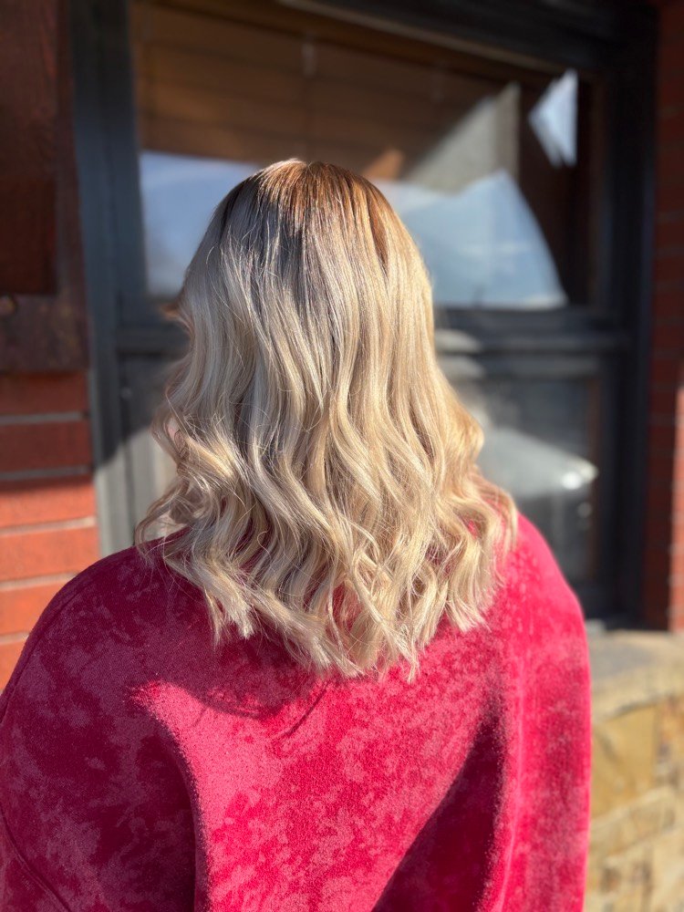 Soft shadow-root blonde balayage with loose waves