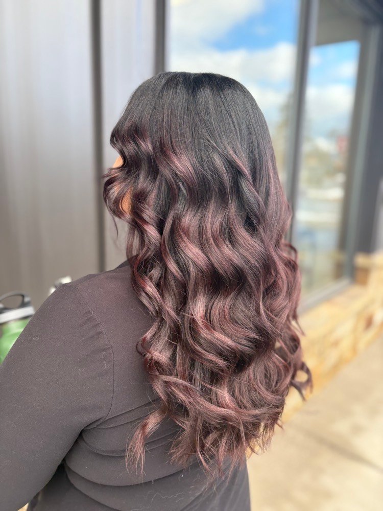 Long brunette hair styled in soft curls