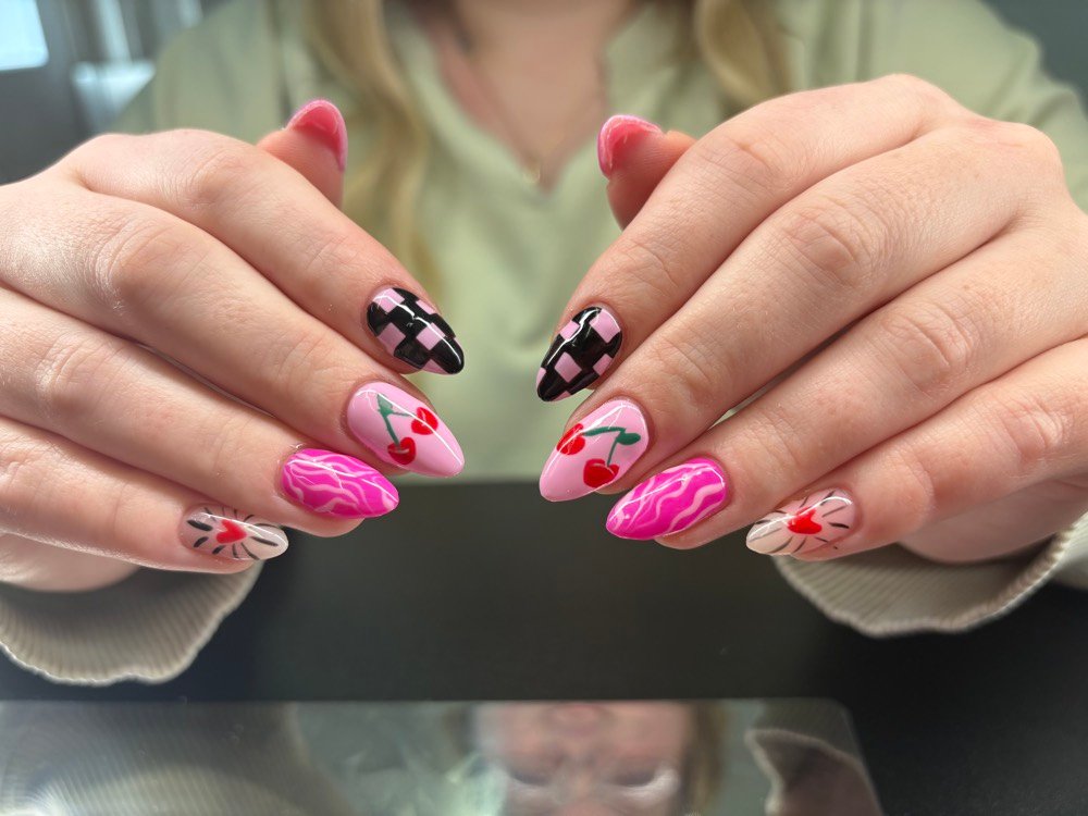 Pink almond nails with checkerboard and cherry art